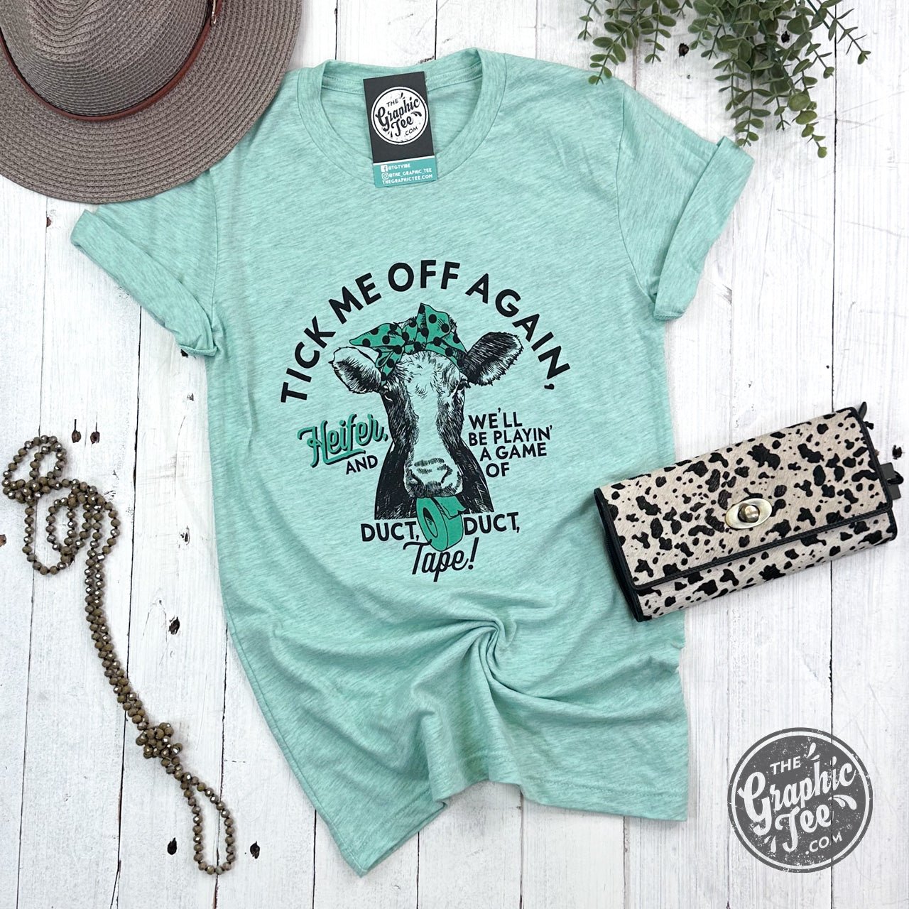 The Graphic Tee Heather Prism Mint short sleeve graphic T-shirt with humorous "Tick Me Off Again" design.