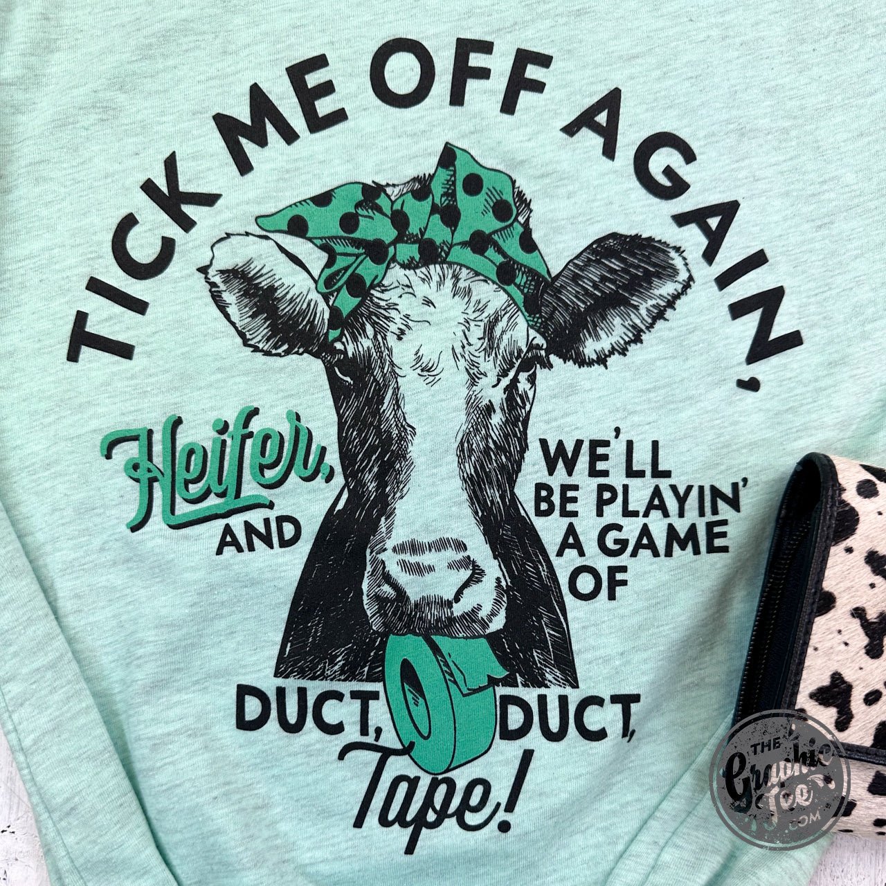 Heifer short sleeve graphic tee in Heather Prism Mint from The Graphic Tee, featuring a casual, colorful design.