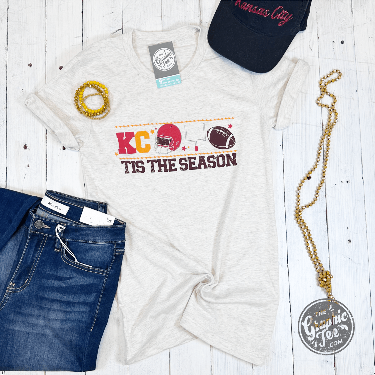 Unisex short sleeve Tis The Season graphic tee by The Graphic Tee, featuring festive holiday design in natural colors.