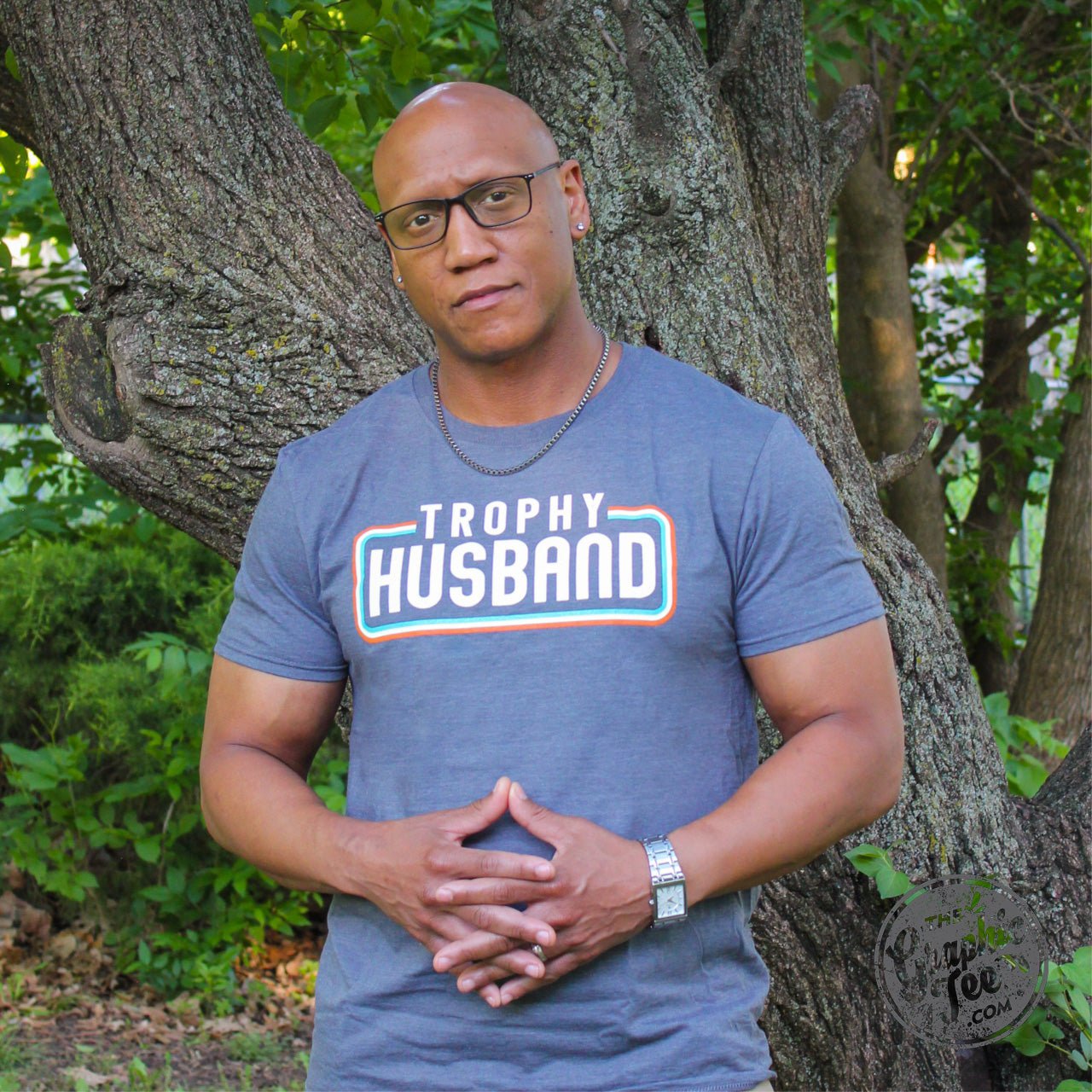 Unisex Trophy Husband SS Graphic Tee by The Graphic Tee featuring a bold printed design on a comfortable cotton shirt.