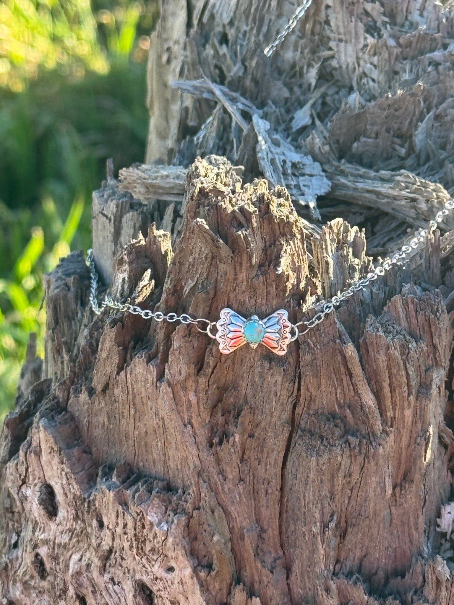 Turquoise butterfly concho chain necklace by Wild Junkie featuring a vibrant turquoise butterfly pendant on a silver chain.