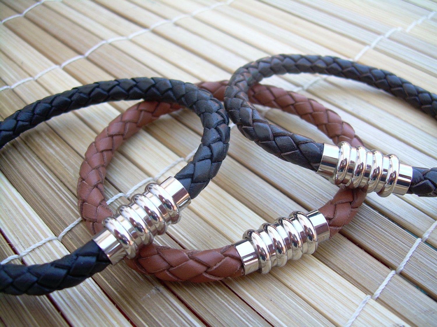 Men's black leather bracelet with stainless steel magnetic clasp, braided design, fits a 6.75-inch wrist, by Urban Survival Gear USA.