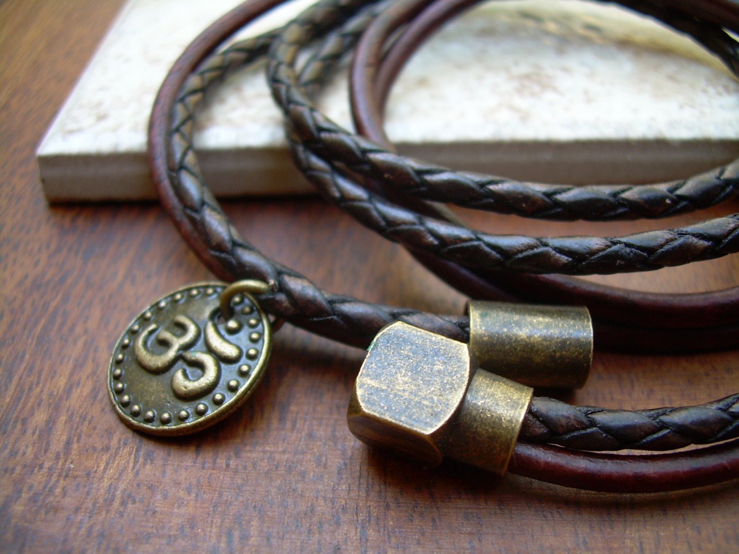 Dark brown leather bracelet with Om charm, antique brass magnetic clasp, triple wrap style, designed by Urban Survival Gear USA