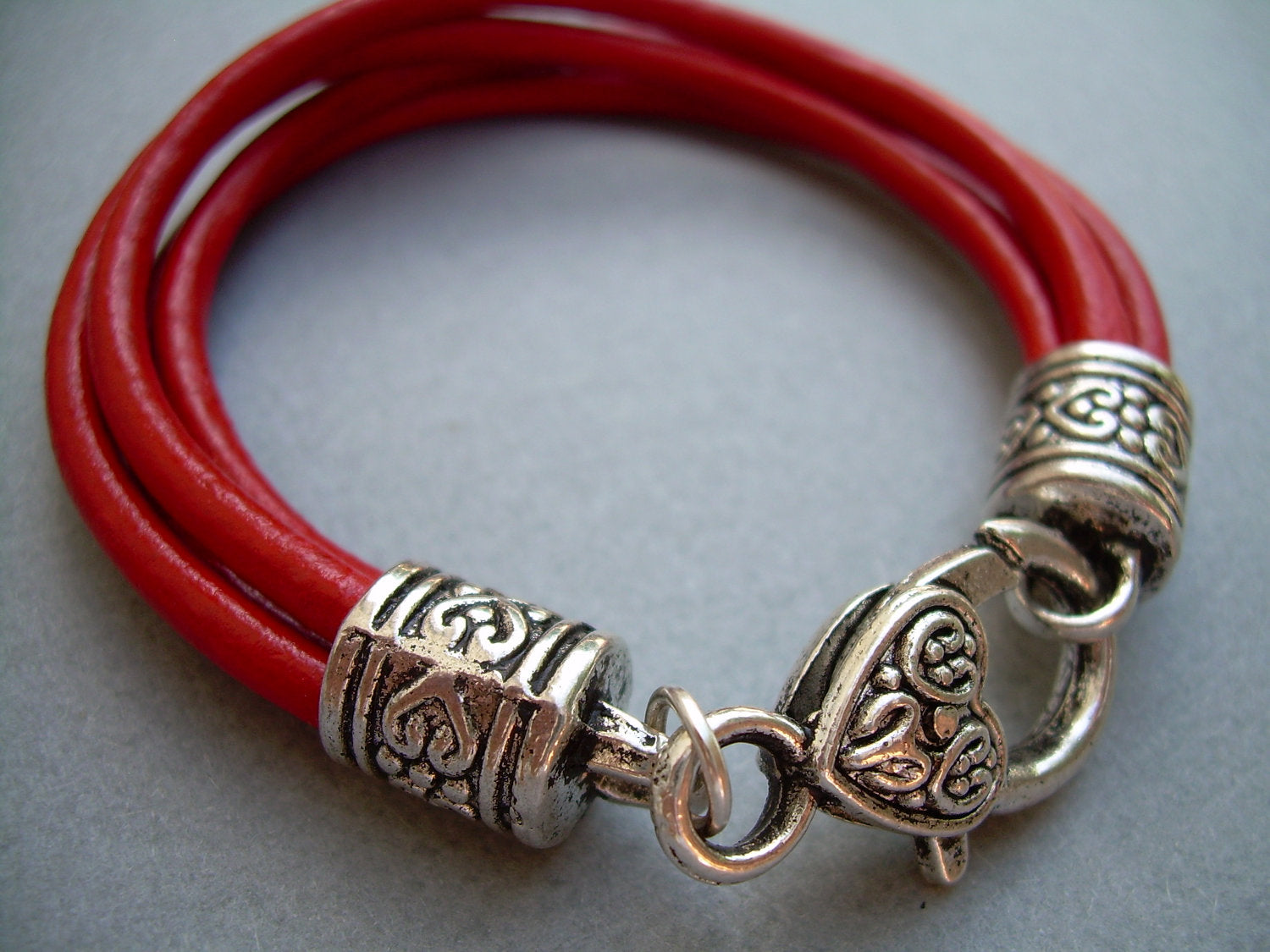 Red leather wristlet bracelet with valet keychain from Urban Survival Gear USA, designed to fit a 6-inch wrist.