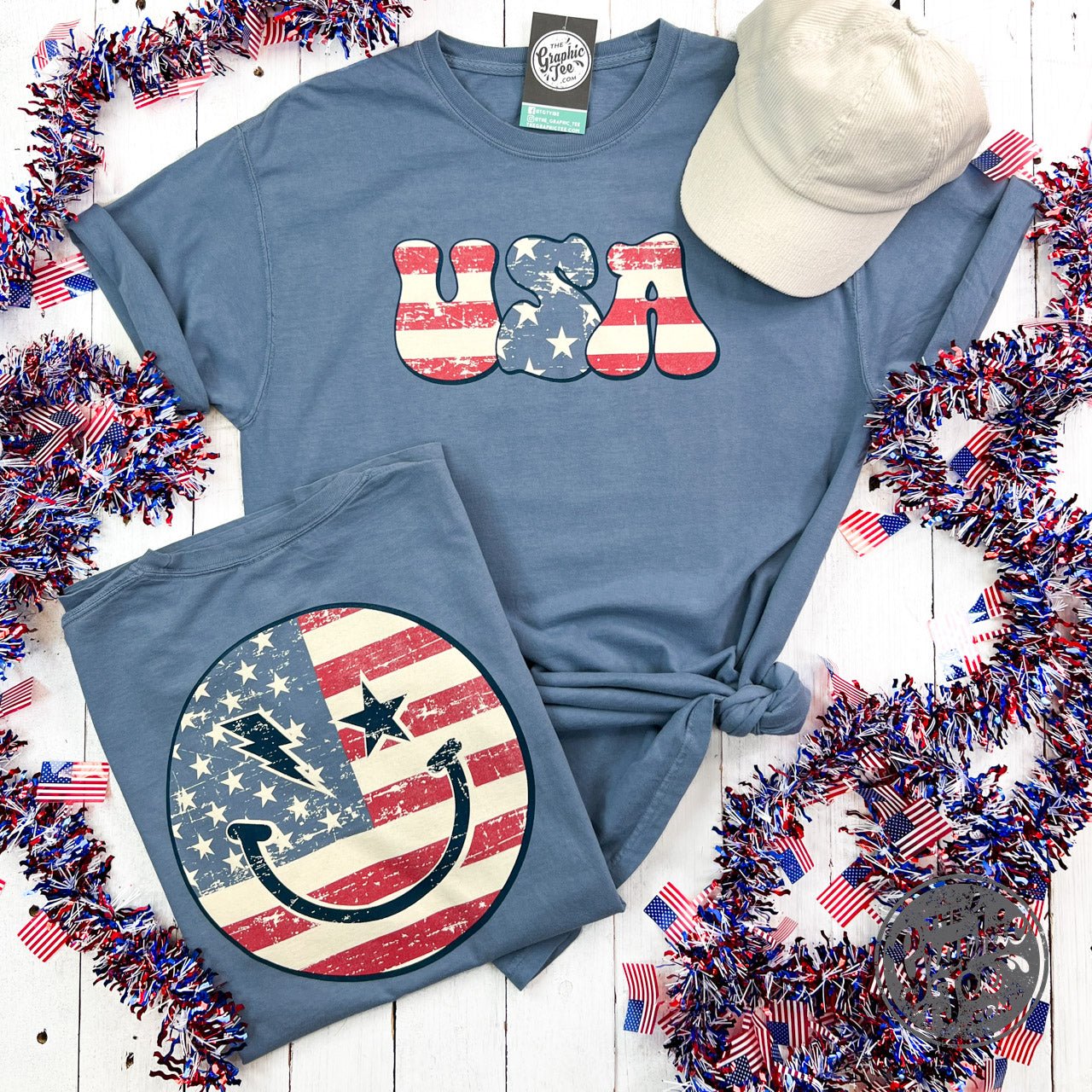 USA Smiley Face Comfort Wash Short Sleeve Tee by The Graphic Tee, featuring a cheerful smiley face graphic on a casual short sleeve T-shirt.