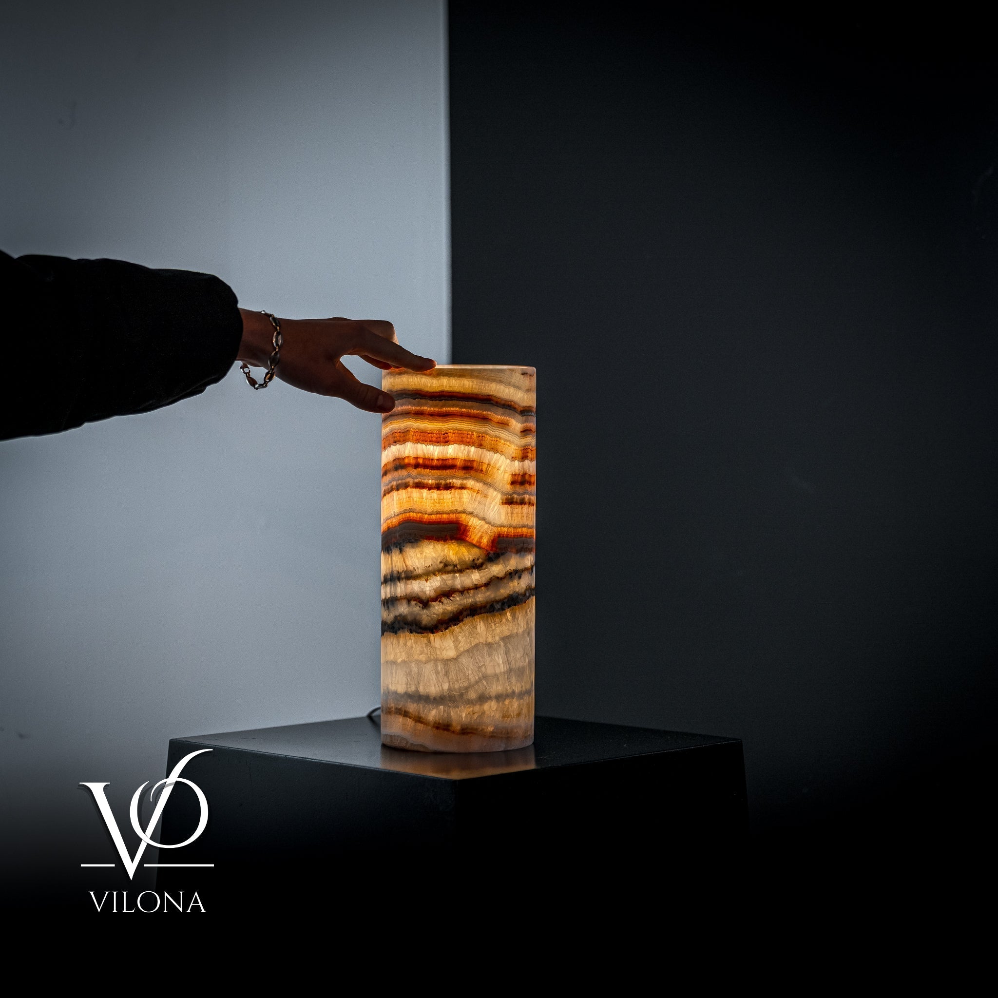 Vilona Onyx Sahara Onyx desk lamp with cylindrical shape and modern design, featuring a sleek black finish and warm lighting.