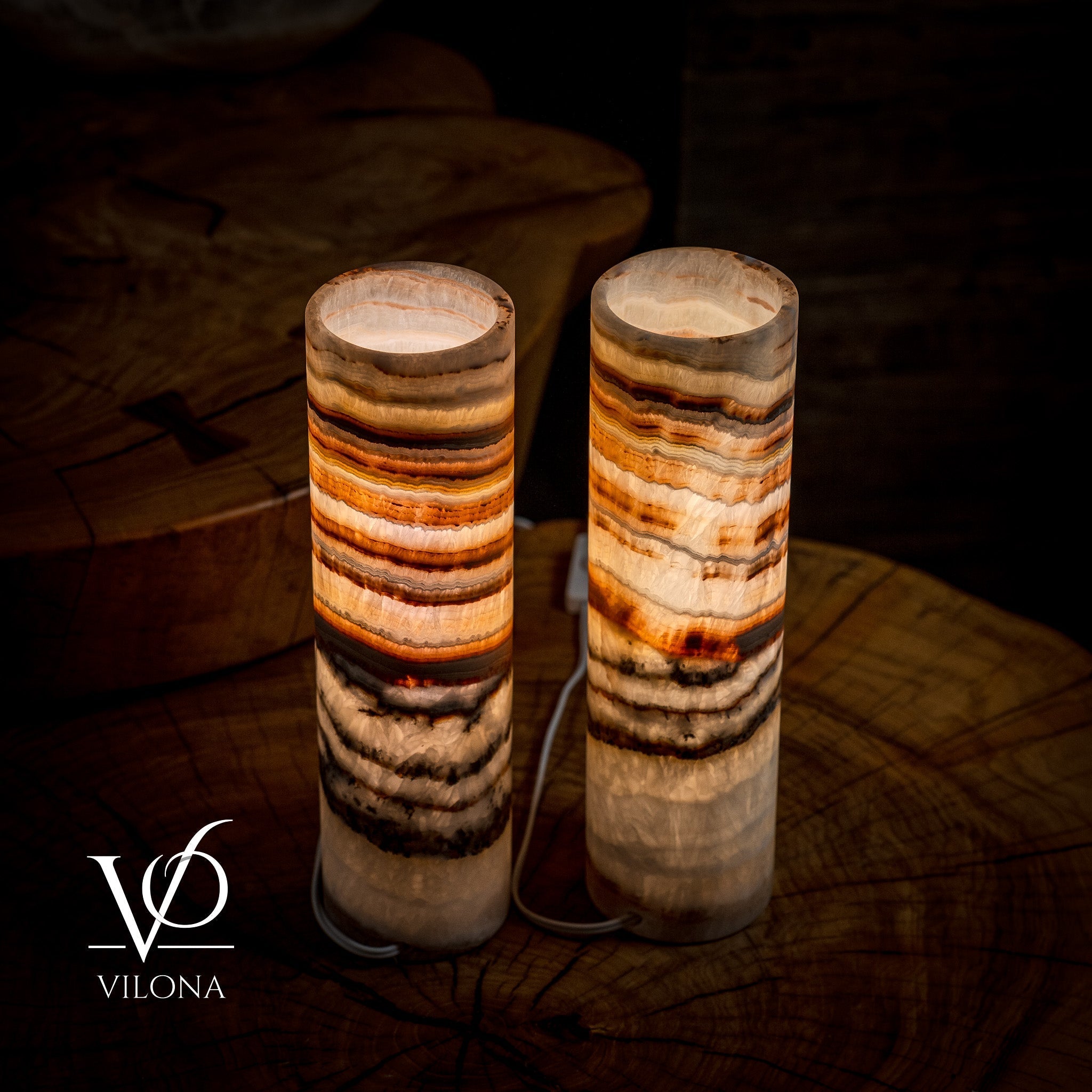 Pair of Vilona Onyx Sahara Onyx desk lamps with cylindrical shape, featuring black and gold finish for elegant table lighting.