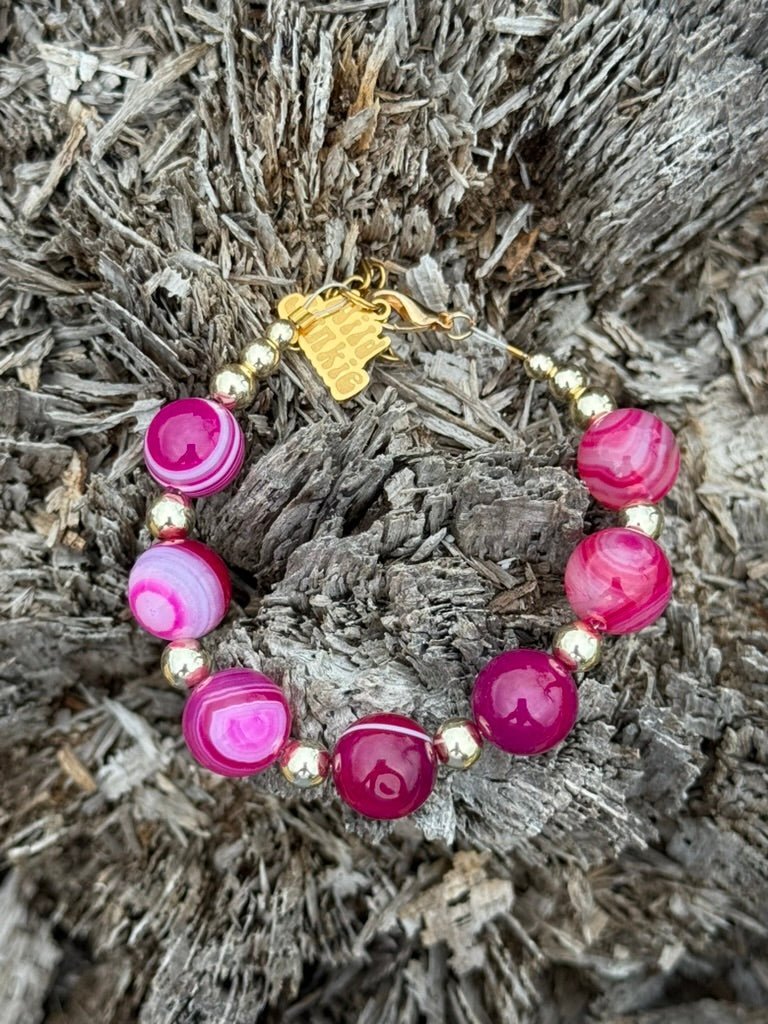 Gold Wild Rose Agate beaded bracelet by Wild Junkie featuring polished rose-colored agate beads on a delicate elastic band.