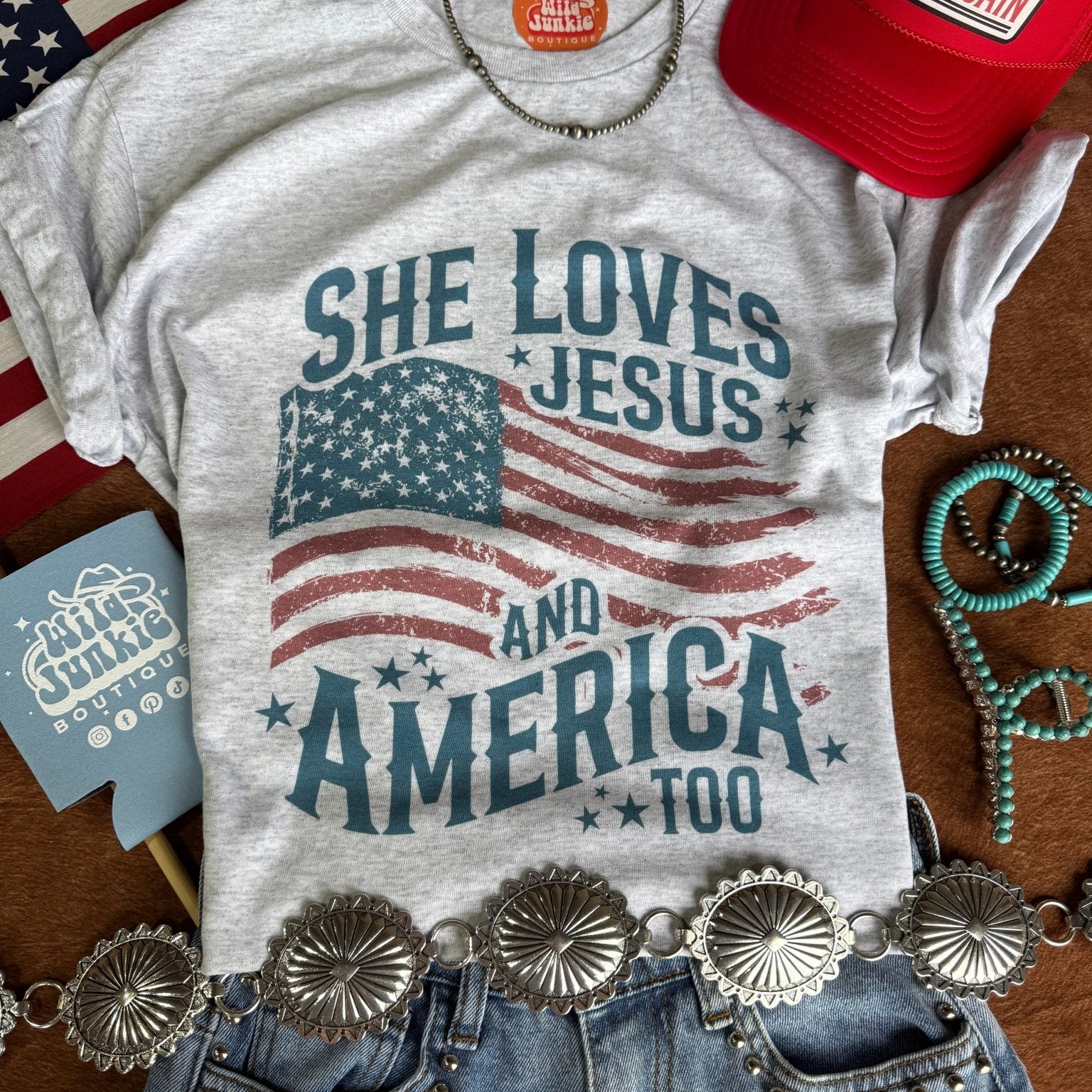 Wild Junkie She Loves Jesus & America graphic tee featuring bold design and patriotic imagery on soft cotton fabric.