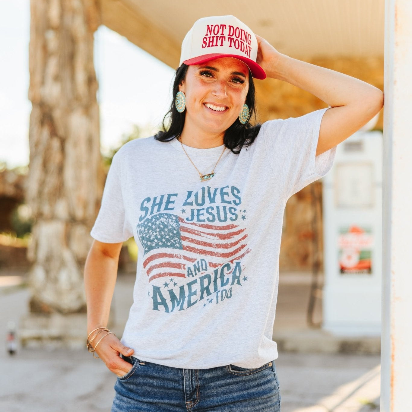 Wild Junkie She Loves Jesus & America graphic tee, white cotton T-shirt with patriotic and faith-themed design for women.