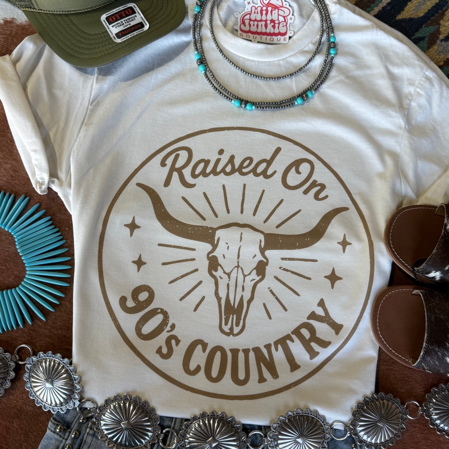 Wild Junkie raised on 90's country steer skull graphic t-shirt showing a vintage style design on soft cotton fabric.
