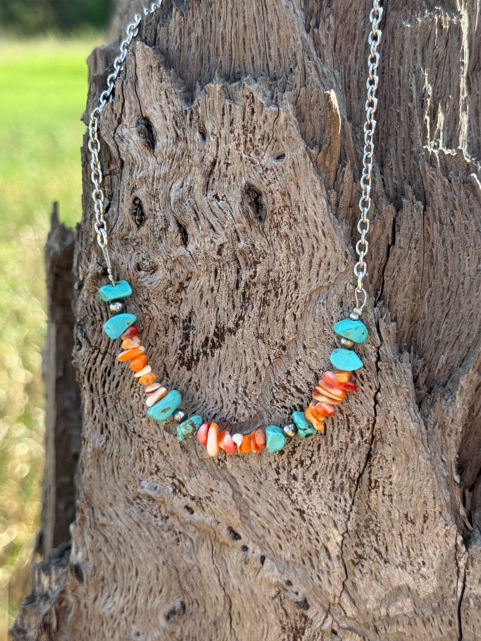 Authentic Spiny Oyster Chip Bead Necklace featuring vibrant orange and red natural stone beads, stylishly strung for a boho look.