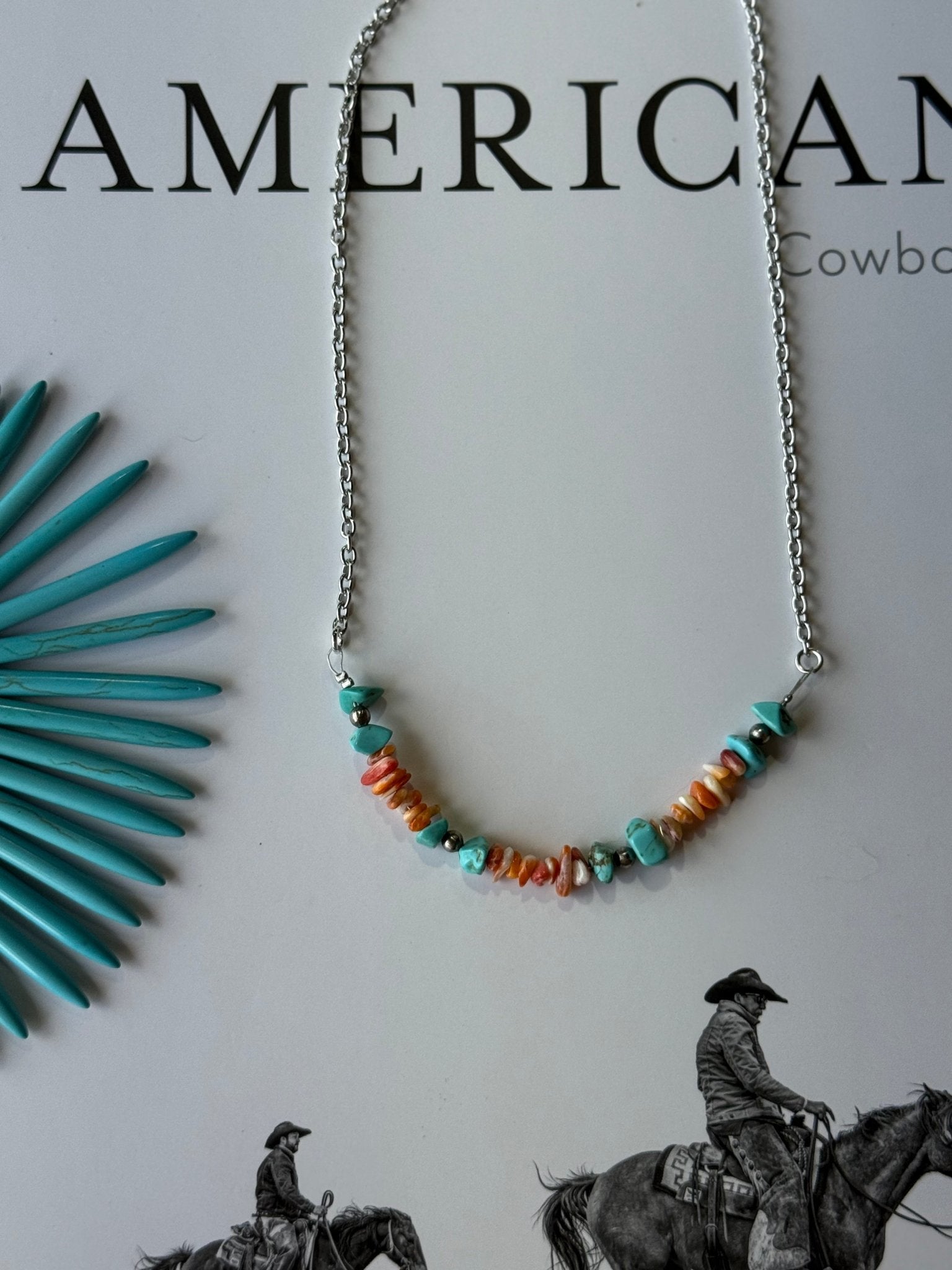 Authentic Spiny Oyster Chip Bead Necklace by Wild Junkie featuring vibrant orange and red natural stone chips on a cord necklace.