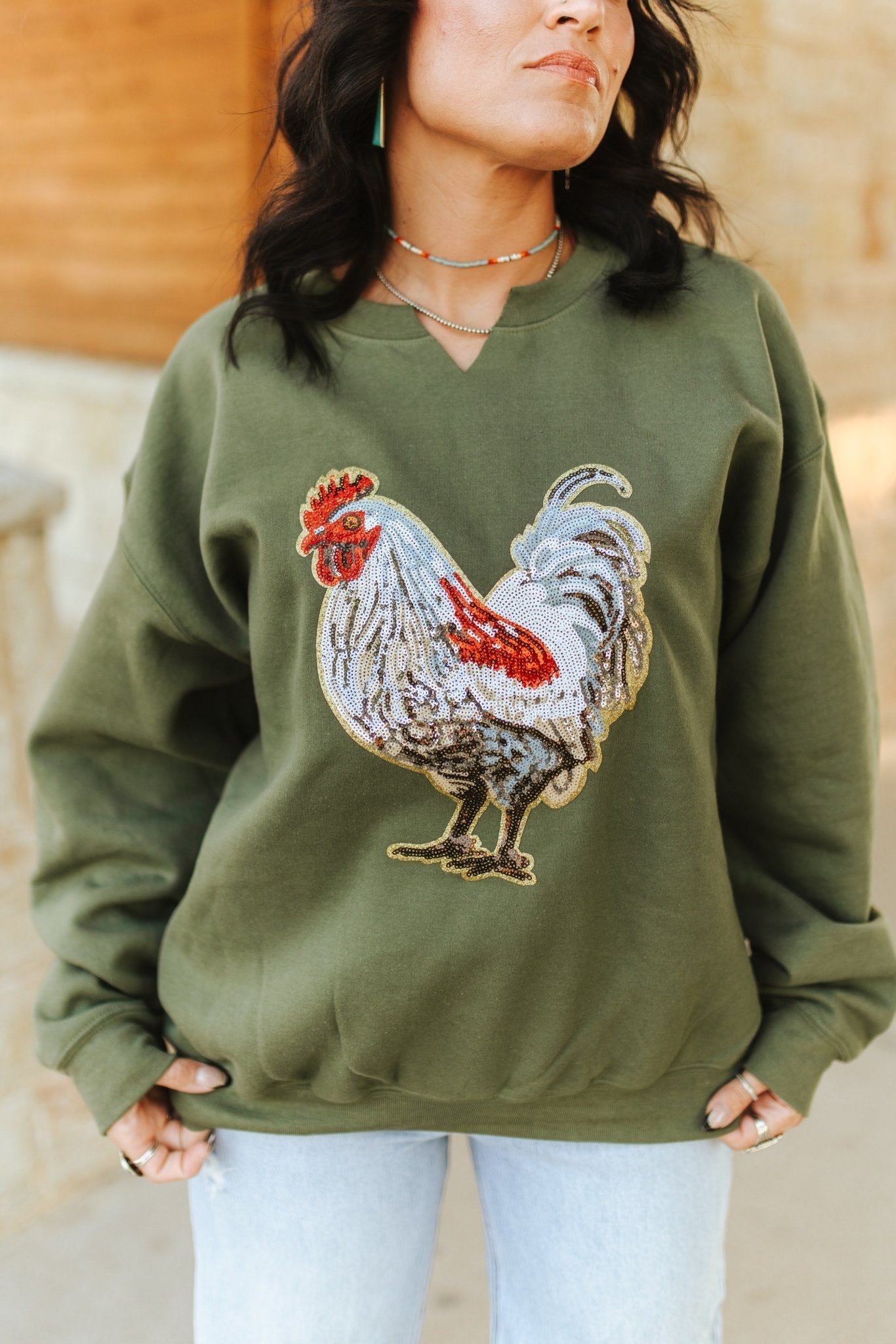Wild Junkie rooster sequin V-neck graphic sweatshirt featuring a colorful rooster design on soft fabric.