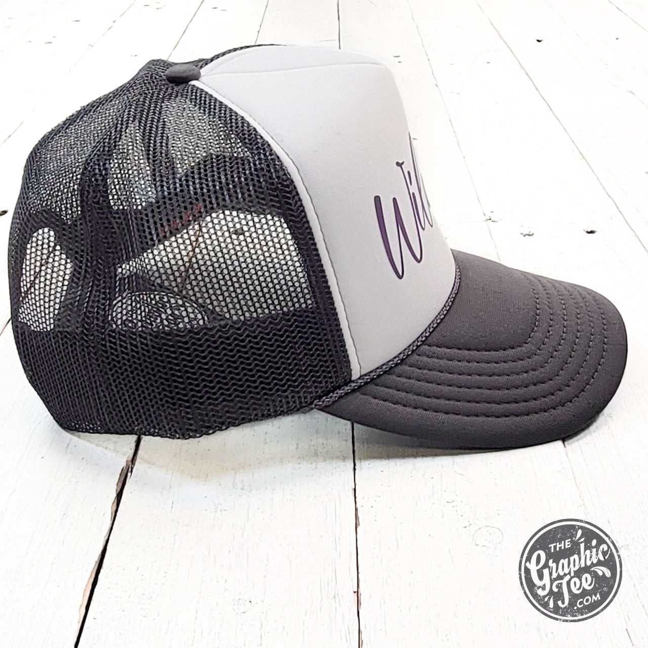 Wildcats charcoal and white foam trucker cap with mesh back and adjustable strap, branded by The Graphic Tee.