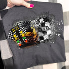 Black racing graphic tee from Anchored Grace Boutique featuring bold racing car and checkered flag design on soft cotton fabric.