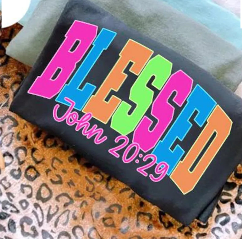 Blessed neon graphic tee from Anchored Grace Boutique featuring a vibrant, colorful design on a casual cotton t-shirt.