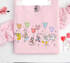 Colorful balloon friends graphic tee for kids by Anchored Grace Boutique, featuring playful balloon illustrations on soft fabric.