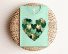 Green hearts graphic tee by Anchored Grace Boutique, soft cotton t-shirt with vibrant heart pattern and casual fit.