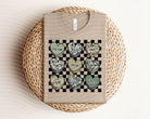 Camo Hearts Graphic Tee by Anchored Grace Boutique, featuring a stylish camouflage design with heart graphics on soft cotton fabric.