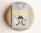 Anchored Grace Boutique Pi-Rate graphic tee featuring a nautical pirate design on soft cotton fabric.