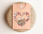 Heart graphic tee by Anchored Grace Boutique featuring a stylish book design on soft fabric, perfect for casual wear.