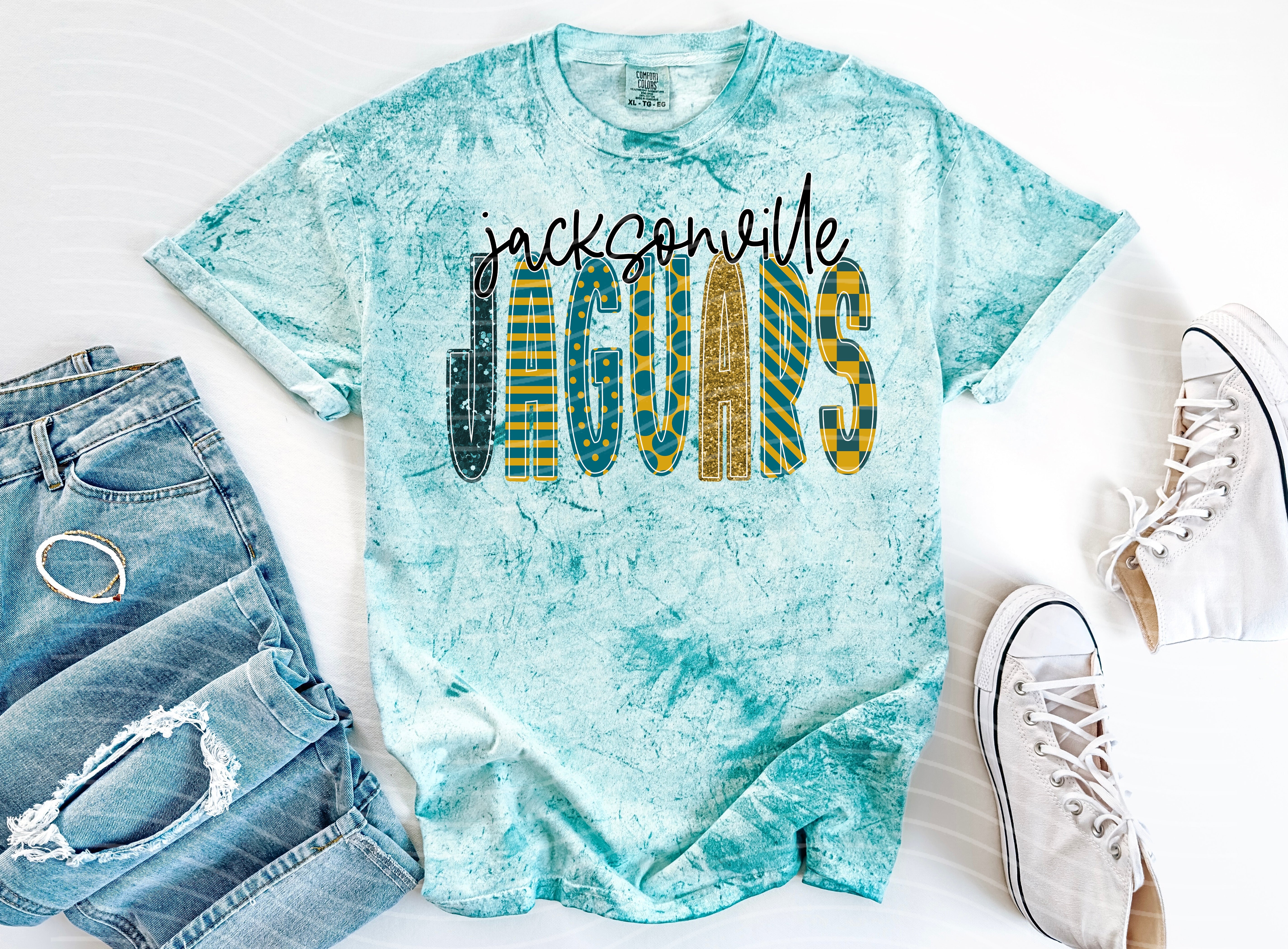 Black Jaguars Doodle Font graphic tee by Anchored Grace Boutique, featuring playful jaguar doodle design on a casual t-shirt.