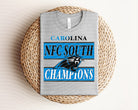 NFC South Champions Panthers graphic tee in black with team logo and text, casual men's cotton t-shirt by Anchored Grace Boutique