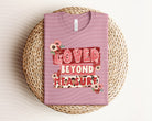 Loved Beyond Measure graphic tee by Anchored Grace Boutique, featuring a stylish design on a comfortable casual T-shirt.