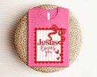 Jesus Loves You graphic tee by Anchored Grace Boutique, featuring a stylish design on a casual cotton t-shirt.