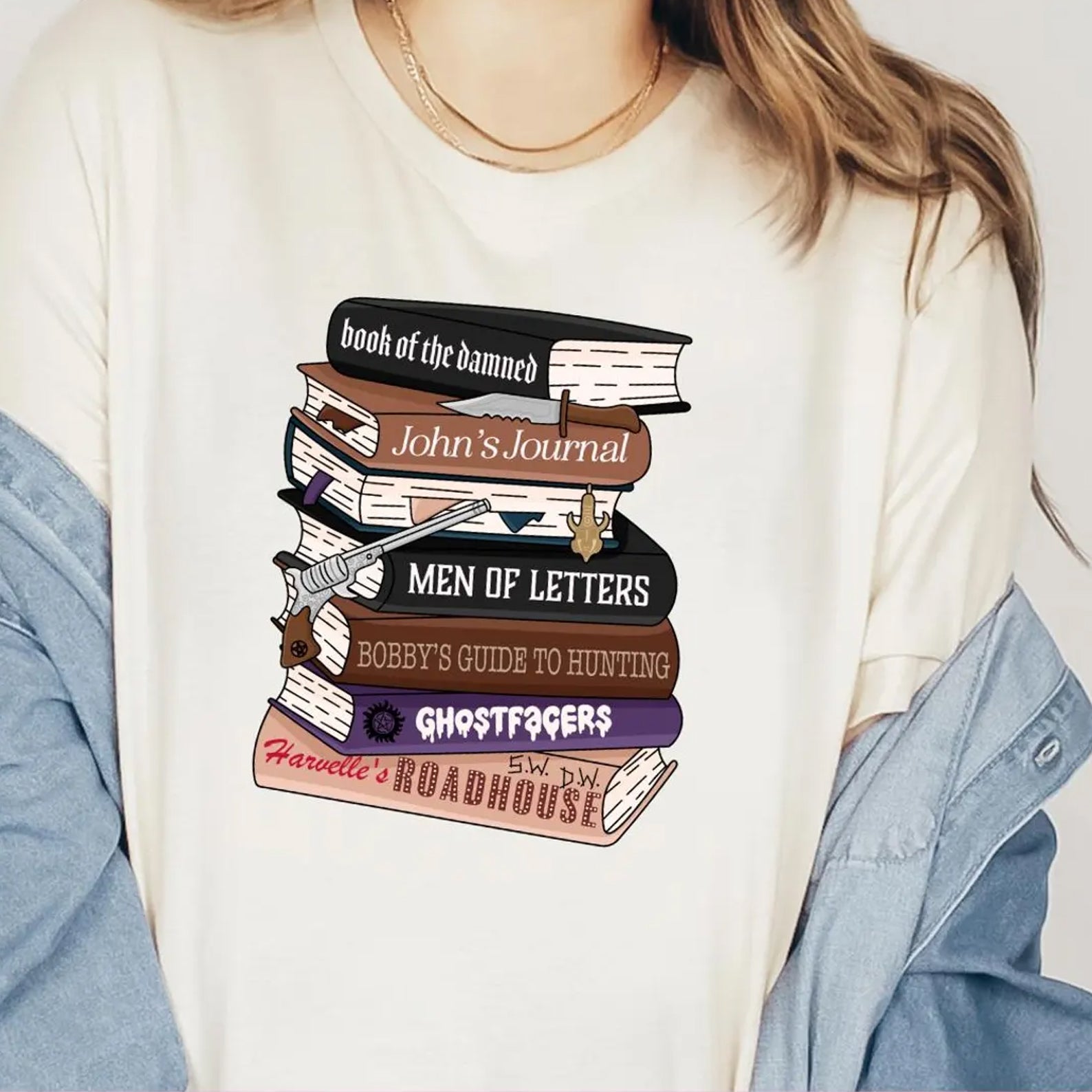 Supernatural Books graphic tee from Anchored Grace Boutique featuring a colorful book-themed design on a casual T-shirt.