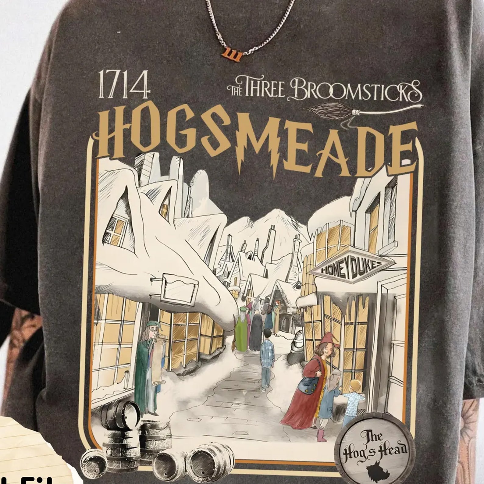 Hogsmeade graphic tee by Anchored Grace Boutique featuring a detailed illustration of Hogsmeade village on soft fabric.