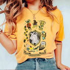 Hufflepuff collage graphic tee from Anchored Grace Boutique featuring Hufflepuff symbols and colors on soft cotton fabric.