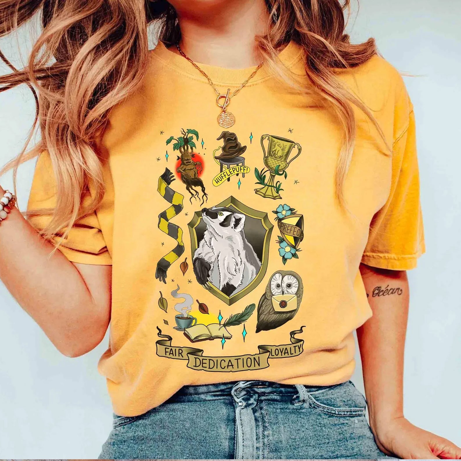 Hufflepuff collage graphic tee from Anchored Grace Boutique featuring Hufflepuff symbols and colors on soft cotton fabric.