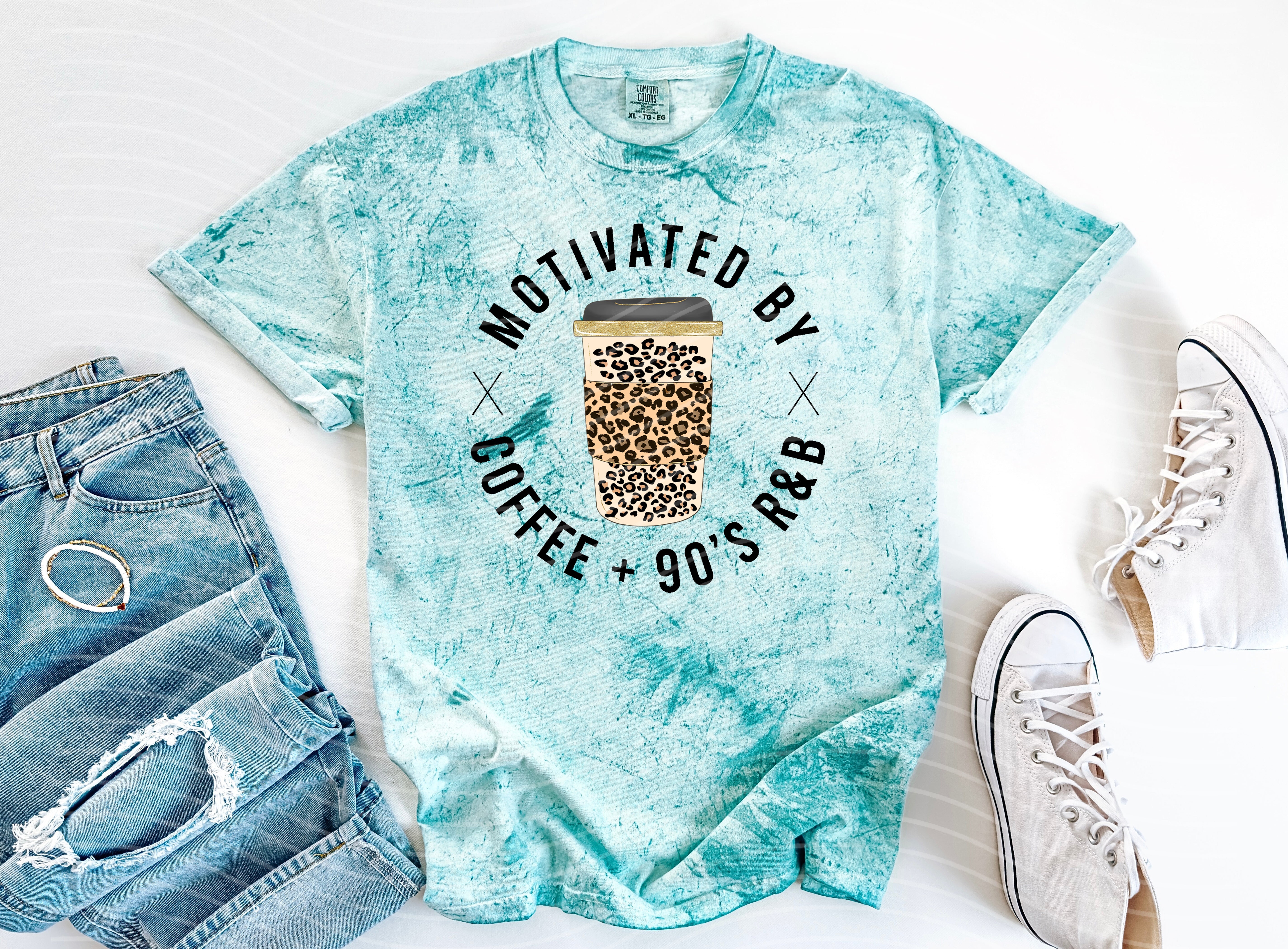 Black graphic tee featuring "Motivated by Coffee and 90's R&B" text, casual style, worn by a model against a neutral background.
