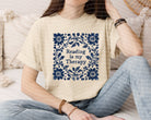 Black graphic tee from Anchored Grace Boutique featuring the phrase "Reading is My Therapy" in stylish white lettering.