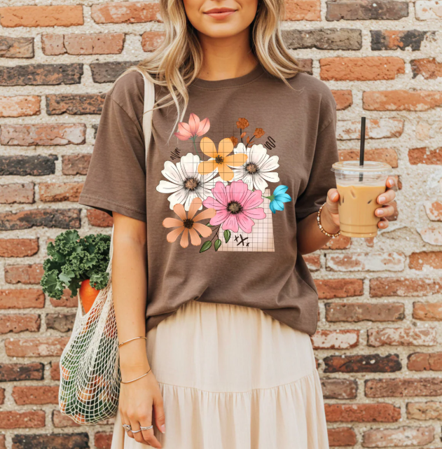 Spring floral graphic tee from Anchored Grace Boutique featuring colorful floral designs on a casual t-shirt.