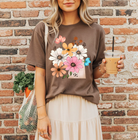 Spring floral graphic tee from Anchored Grace Boutique featuring colorful floral designs on a casual t-shirt.