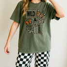 Wild & Free graphic tee by Anchored Grace Boutique featuring a stylish, casual design with bold print on soft fabric.