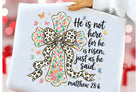 Black He is Not Here graphic tee from Anchored Grace Boutique, featuring a bold printed design on soft cotton fabric.