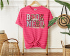 Black Book Nerd graphic tee from Anchored Grace Boutique featuring a book-themed design on soft cotton fabric.