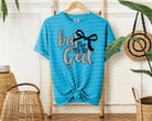 Black But God graphic tee by Anchored Grace Boutique featuring bold white text on soft cotton fabric.