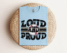 Loud and Proud baseball graphic tee by Anchored Grace Boutique featuring bold lettering and casual fit on model.