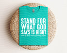 Black graphic tee from Anchored Grace Boutique with "Stand for What God Says is Right" slogan and biblical design.