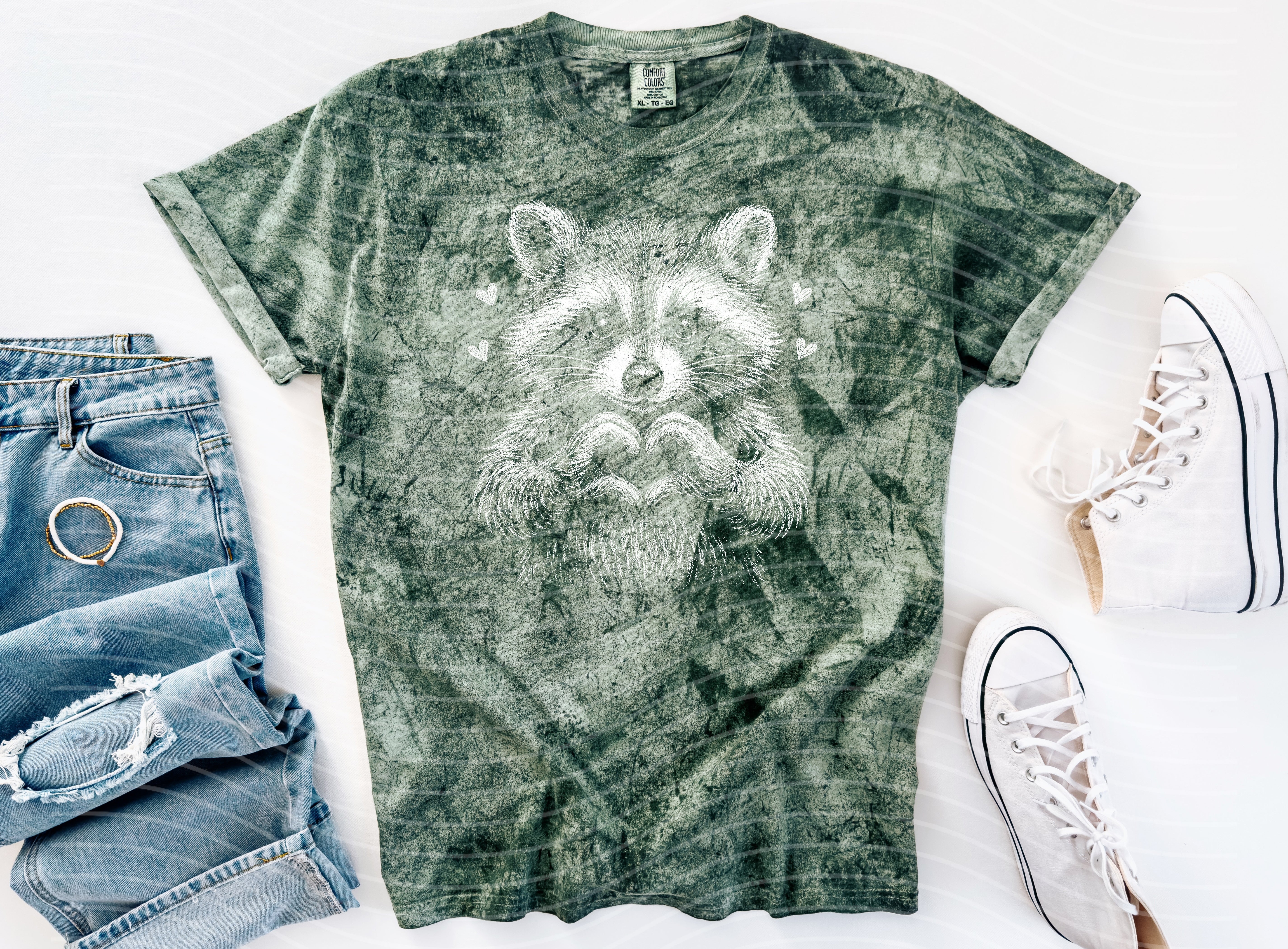 Black and white raccoon graphic tee from Anchored Grace Boutique, featuring a stylish raccoon illustration on a casual t-shirt.