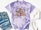 Black graphic tee from Anchored Grace Boutique featuring "Just One More Chapter" text and book-themed design.