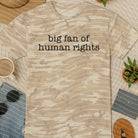 Black graphic tee featuring "Big Fan of Human Rights" design from Anchored Grace Boutique, casual wear with bold statement print.
