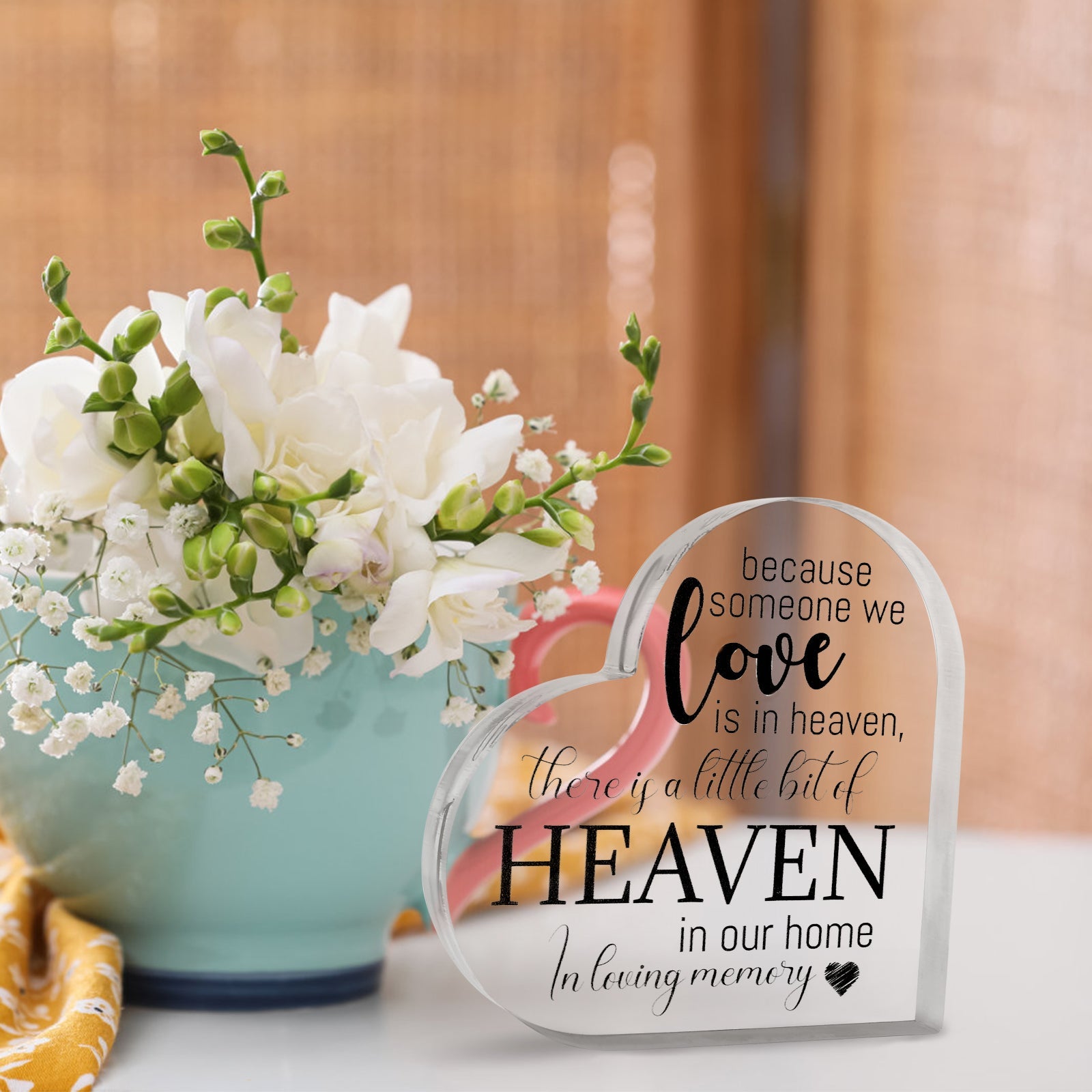 Acrylic memorial heart with "Heaven In Our Home" inscription in a gift box, from The Wind Chime Co, resting on a white surface.