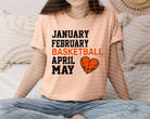 Graphic tee featuring January, February, April, and May basketball-themed designs by Anchored Grace Boutique.