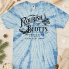 Anchored Grace Boutique Flourish and Blotts graphic tee featuring a colorful book-themed design on a casual cotton t-shirt.